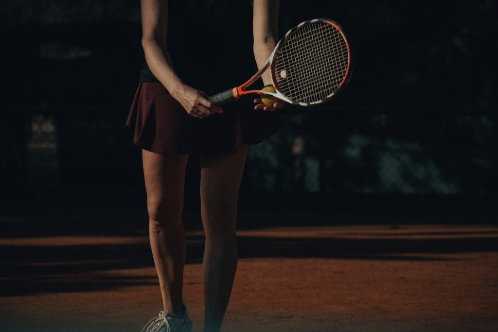 female student athlete playing tennis