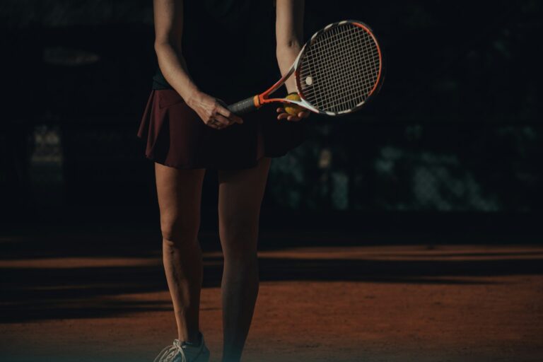female student athlete playing tennis