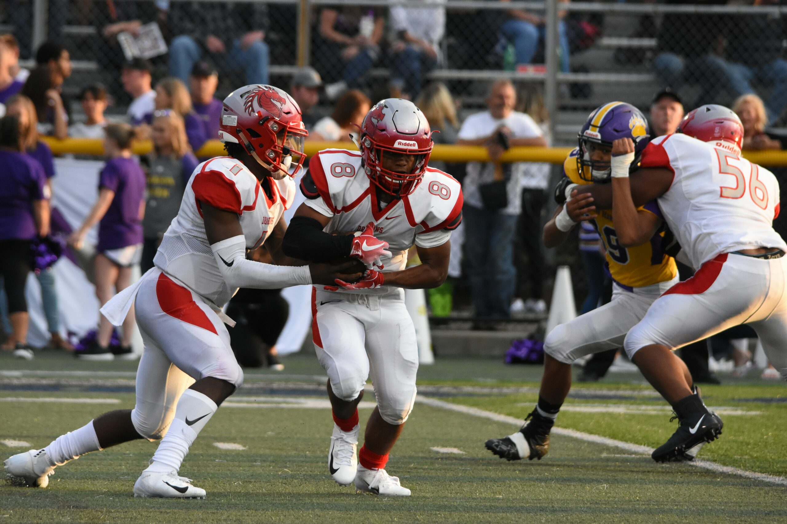College football players passing the ball